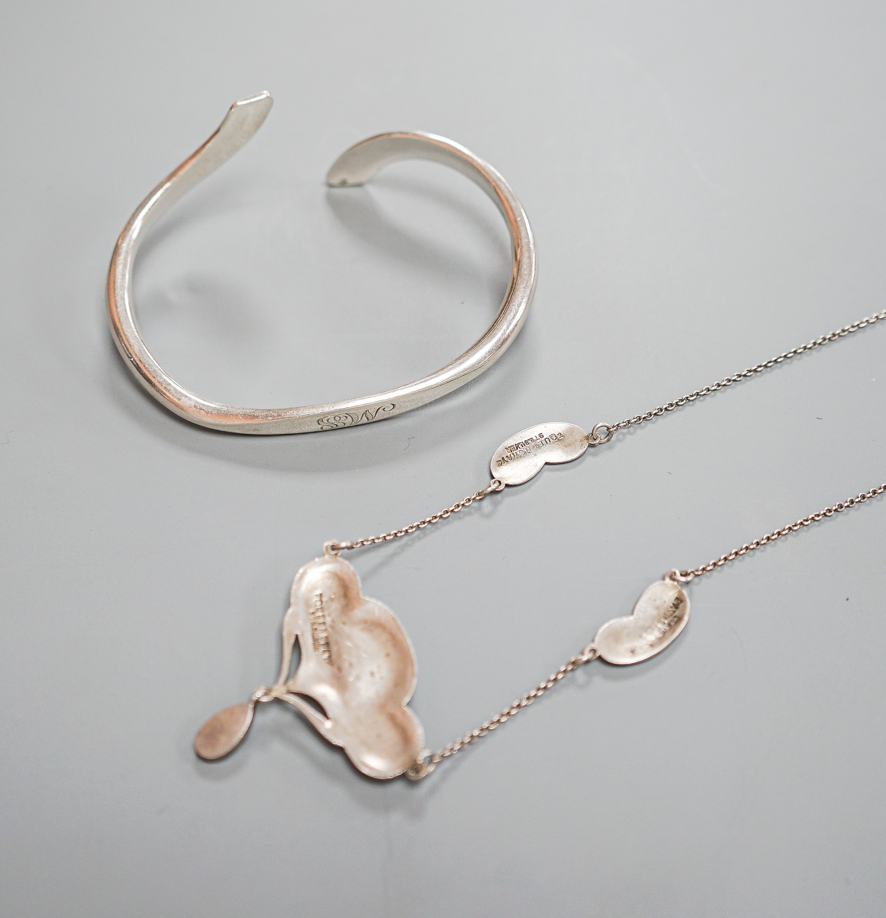 An Art Nouveau style sterling and mother of pearl set pendant necklace, stamped Queensway, 62cm and a white metal bangle.